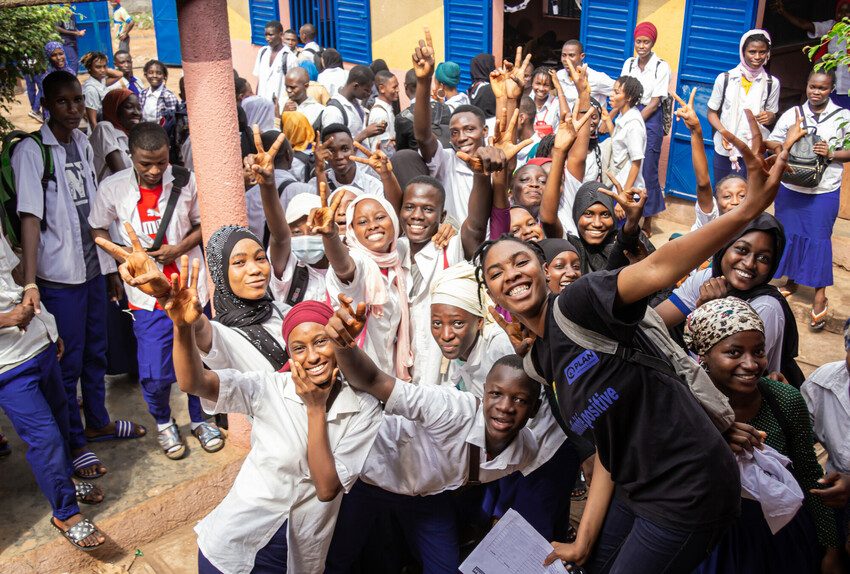 A youth group are cheering at and event to end FGM.