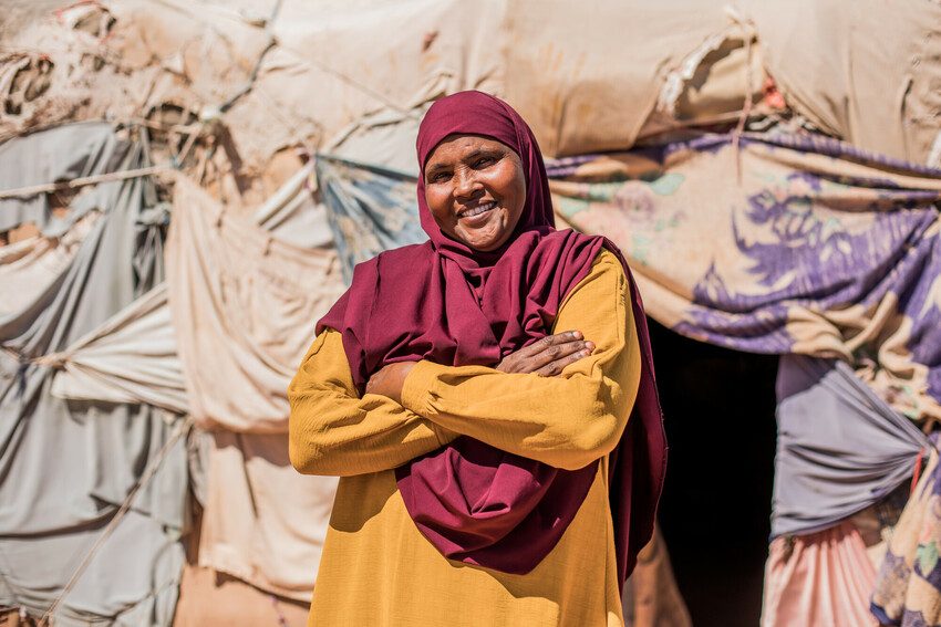 Saafi standing with her arms folded.