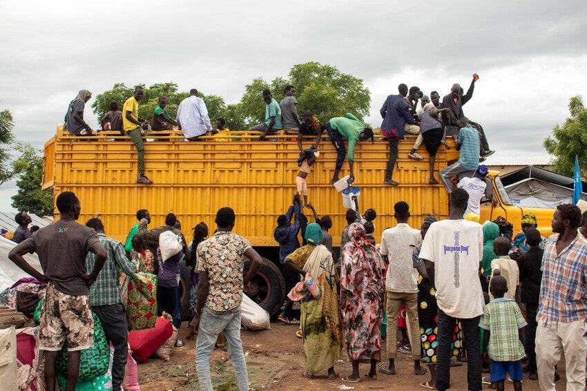 People sit on a transport truck in Renk hoping to move on and find safety.