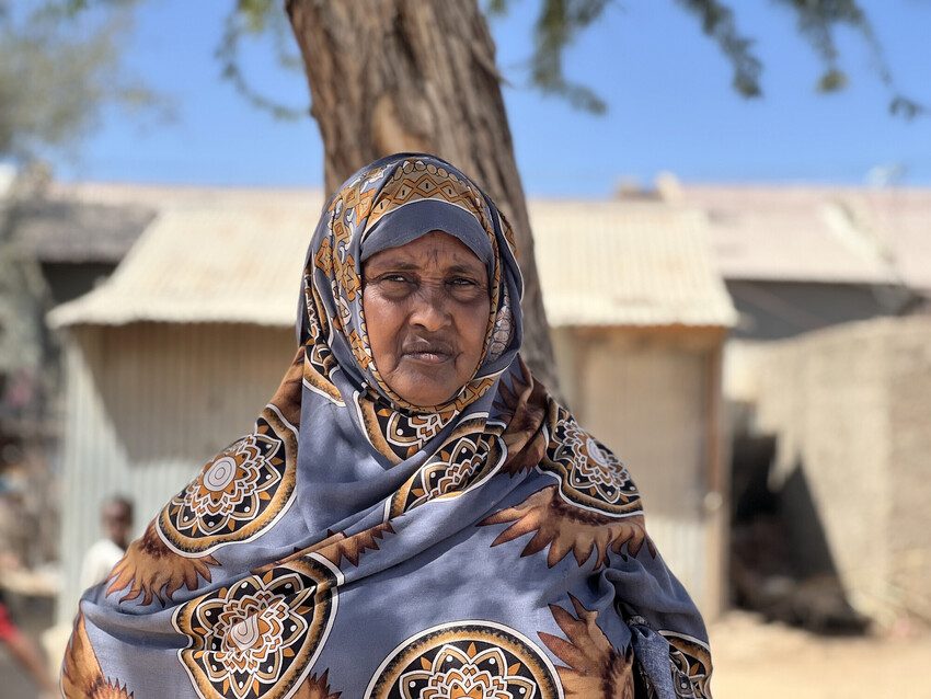 Ruqiya stands facing the camera. Once a cutter Ruqiya now advocates against the practice of female genital mutilation.